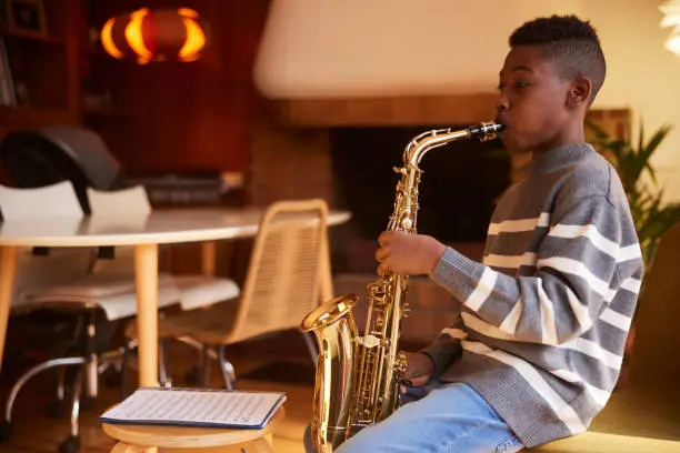 praxis future academy boy playing instrument